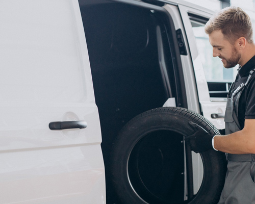 Mobile tyre van servicing a vehicle
